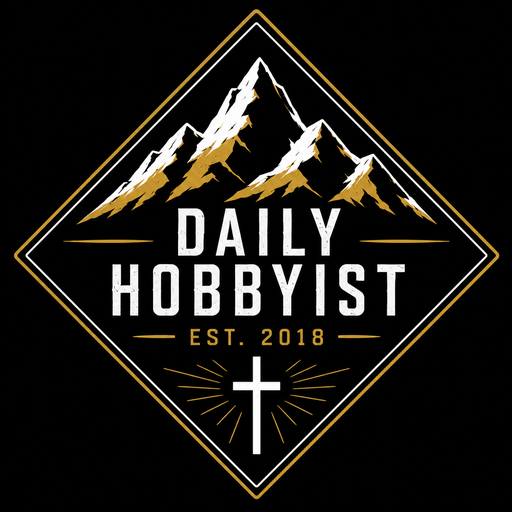 Daily Hobbyist logo — a mountain range inside a gold diamond with a cross, established 2018